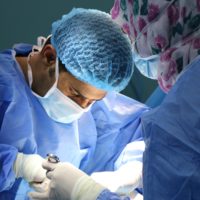 a surgeon and a nurse perform an operation