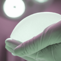 surgeon holding breast implant