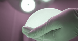surgeon holding breast implant