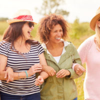 a group of women standing and smiling