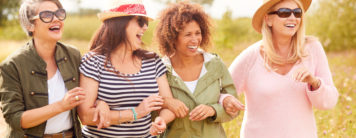 a group of women standing and smiling